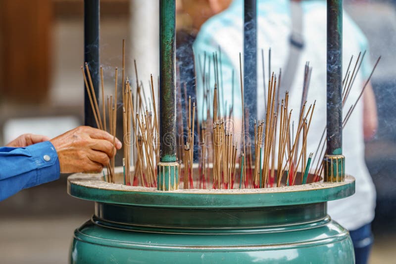 how to light an incense People light incense sticks for praying in japan stock photo